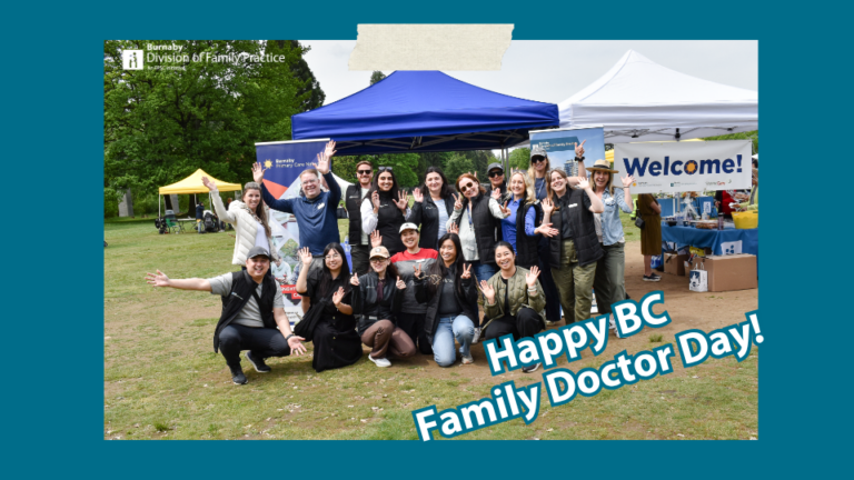 Group photo of BDFP staff standing in front of BDFP and PCN branded roll-up banners.