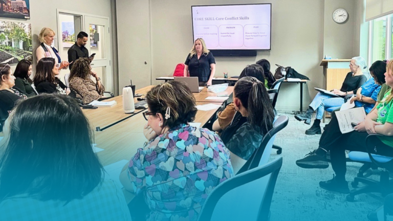 Nurses sitting in a board room during a Communication That Connect education session